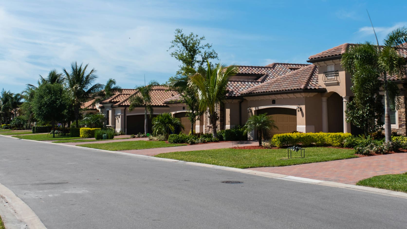 Illustrative street of newly developed houses in a landscaped residential estate